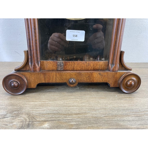 558 - A 19th century mahogany cased mantle clock with hand carved roundels, glass front and hand-painted d... 