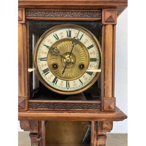 561 - An early 20th century German Berliner carved walnut chiming wall clock - approx. 83cm high x 23cm wi... 