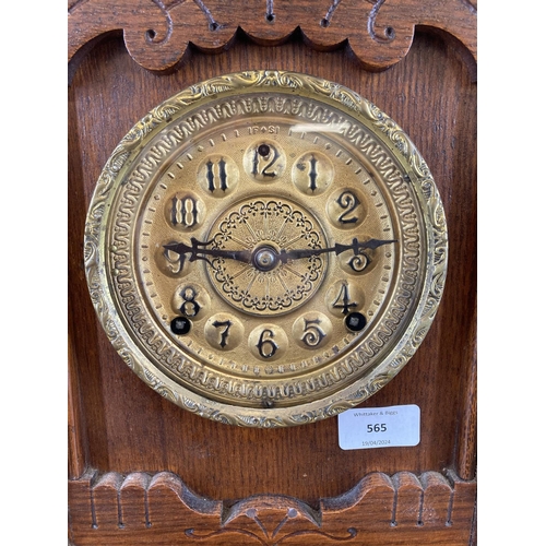 565 - A late 19th century American 'gingerbread' oak cased chiming mantel clock - approx. 48cm high x 35cm... 