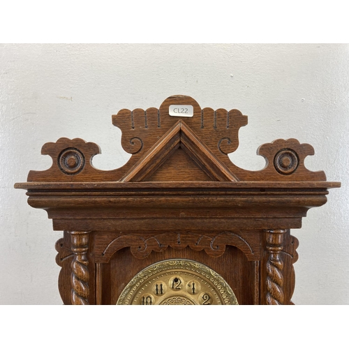 565 - A late 19th century American 'gingerbread' oak cased chiming mantel clock - approx. 48cm high x 35cm... 