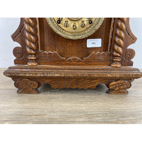 565 - A late 19th century American 'gingerbread' oak cased chiming mantel clock - approx. 48cm high x 35cm... 