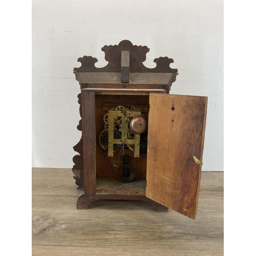 565 - A late 19th century American 'gingerbread' oak cased chiming mantel clock - approx. 48cm high x 35cm... 