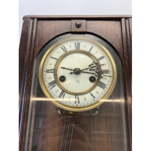 569 - An early/mid 20th century mahogany cased wall clock - approx. 55cm high x 22cm wide