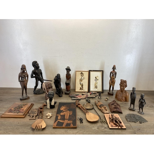 572 - A collection of African figurines and wall plaques to include carved teak wall mask, butterfly wing ... 