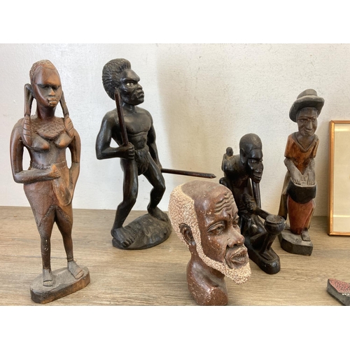 572 - A collection of African figurines and wall plaques to include carved teak wall mask, butterfly wing ... 