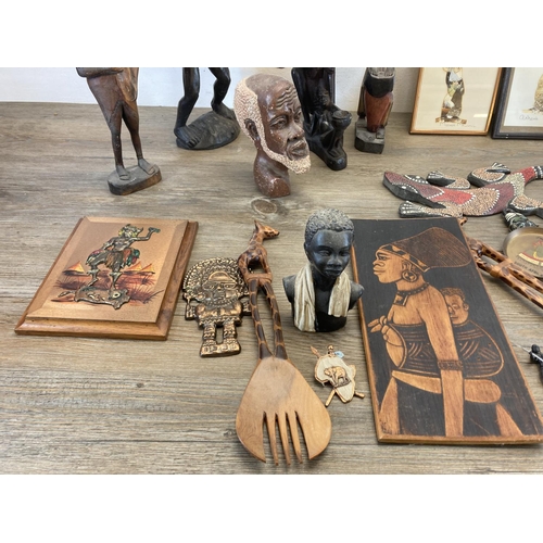 572 - A collection of African figurines and wall plaques to include carved teak wall mask, butterfly wing ... 