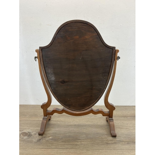 574 - An Edwardian mahogany shield shaped bathroom swing mirror - approx. 49cm high x 34cm wide