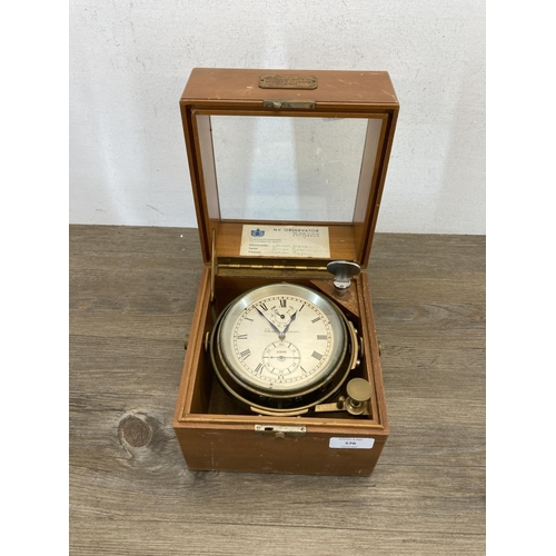 A vintage Thomas Mercer two day marine chronometer with state of wind and second dials in original wooden case with brass plaque inscribed 'Supplied by Dobbie McInnes Ltd. London & Glasgow No.21949'