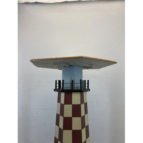 577 - A hand-painted plywood side table in the form of a lighthouse - approx. 59cm high