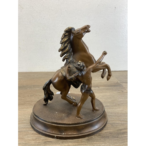 587 - A pair of bronzed spelter rearing horse figurines - approx. 22cm high