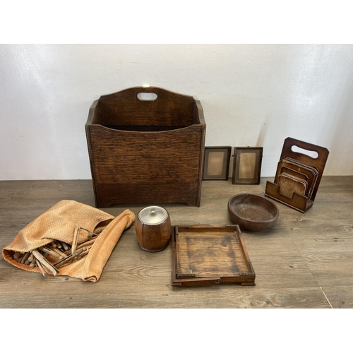 591 - A collection of treenware to include 1930s oak tea caddy with ceramic liner, 1940s oak magazine hold... 