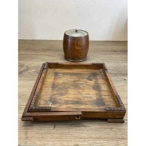 591 - A collection of treenware to include 1930s oak tea caddy with ceramic liner, 1940s oak magazine hold... 