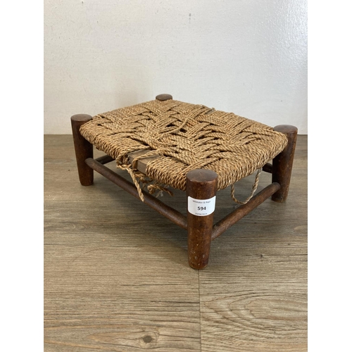 594 - Two early 20th century oak and rush seated footstools - largest approx. 23cm high x 32cm wide x 27cm... 