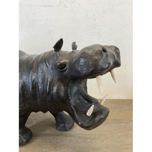 598 - Two mid 20th century leather animal figurines, one hippo and one rhino - largest approx. 26cm high x... 