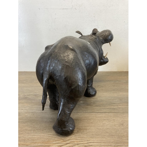 598 - Two mid 20th century leather animal figurines, one hippo and one rhino - largest approx. 26cm high x... 