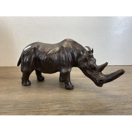 598 - Two mid 20th century leather animal figurines, one hippo and one rhino - largest approx. 26cm high x... 