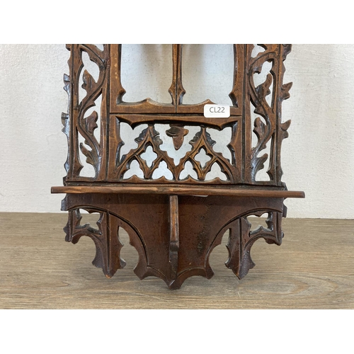 599 - A 19th century Gothic Revival carved wooden wall hanging plaque with lower shelf - approx. 40cm high... 