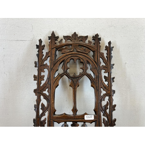 599 - A 19th century Gothic Revival carved wooden wall hanging plaque with lower shelf - approx. 40cm high... 