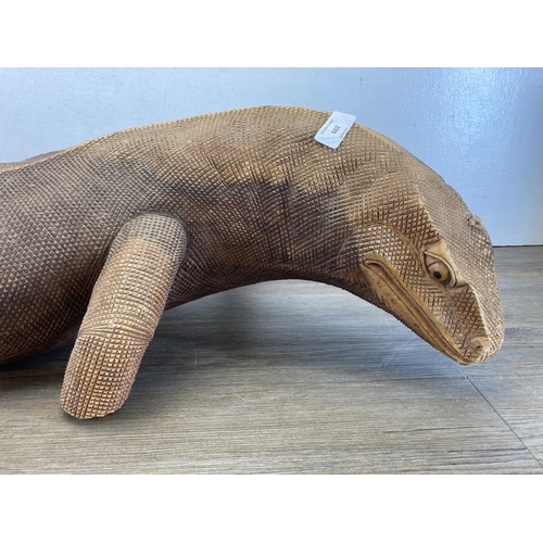 602 - A large hand carved hardwood Komodo dragon figurine - approx. 91cm long