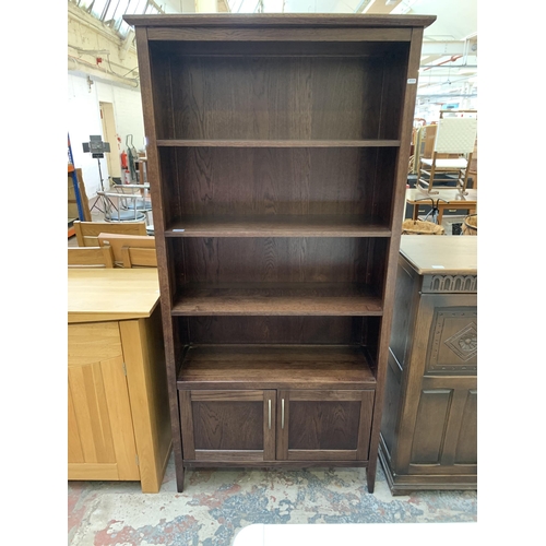 104 - A modern oak four tier bookcase - approx. 180cm high x 85cm wide x 33cm deep