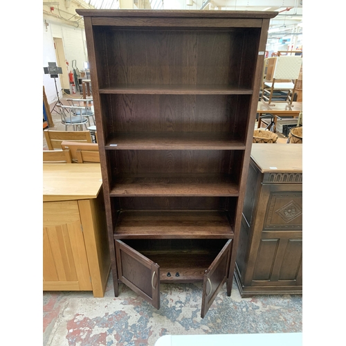 104 - A modern oak four tier bookcase - approx. 180cm high x 85cm wide x 33cm deep