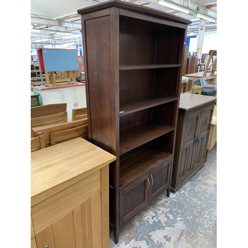 104 - A modern oak four tier bookcase - approx. 180cm high x 85cm wide x 33cm deep