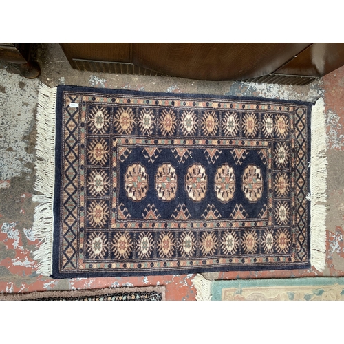 122 - Three rugs, one G.H.Frith Ltd. Pakistan Bokhara Blue - approx. 91cm x 61cm, one Frith Rugs Pakistan ... 