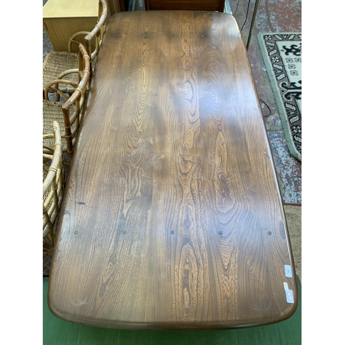 128 - An Ercol Golden Dawn elm dining table - approx. 72cm high x 87cm wide x 182cm long