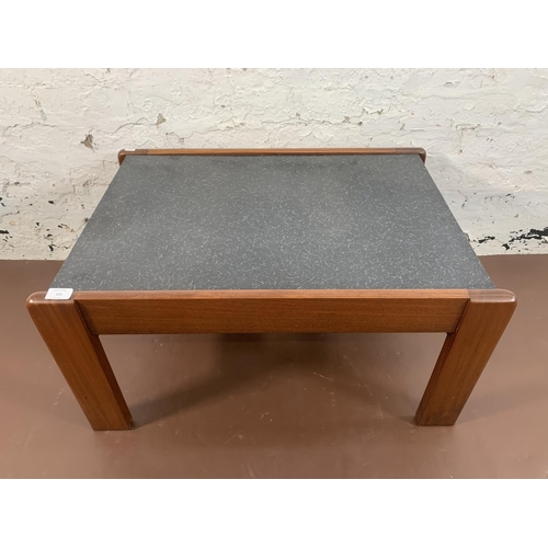 131 - A mid 20th century teak and black laminate rectangular coffee table - approx. 40cm high x 55cm wide ... 