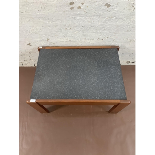 131 - A mid 20th century teak and black laminate rectangular coffee table - approx. 40cm high x 55cm wide ... 