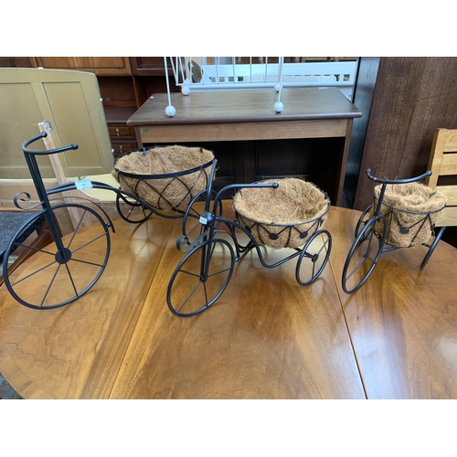 136 - Three wrought metal tricycle garden planters - largest approx. 41cm high x 67cm long