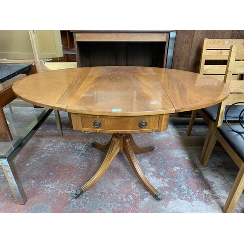 137 - A Regency style yew wood oval drop leaf pedestal breakfast table - approx. 78cm high x 94cm wide x 1... 