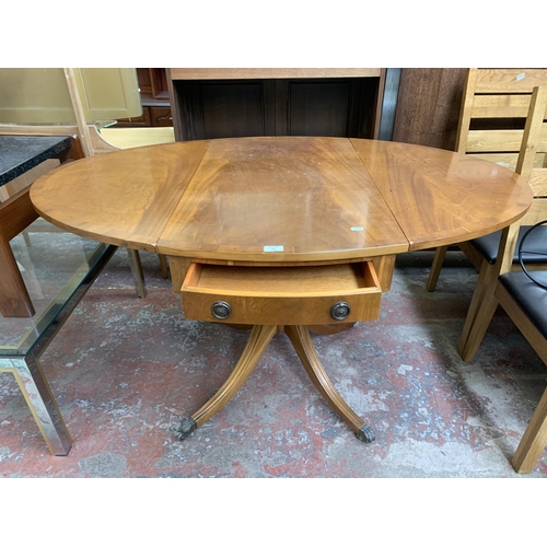 137 - A Regency style yew wood oval drop leaf pedestal breakfast table - approx. 78cm high x 94cm wide x 1... 