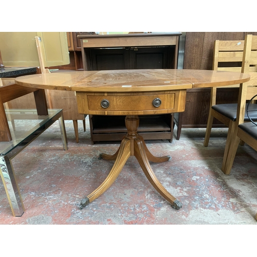 137 - A Regency style yew wood oval drop leaf pedestal breakfast table - approx. 78cm high x 94cm wide x 1... 