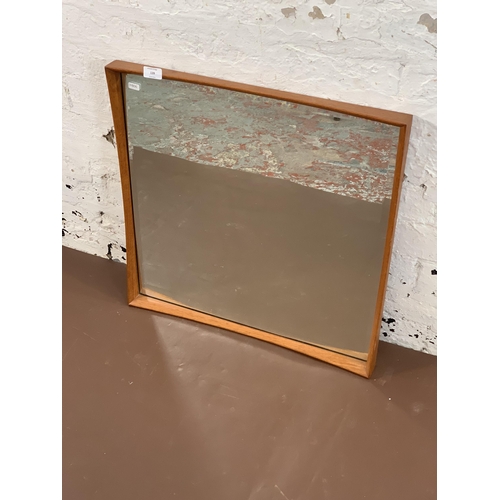 139 - A mid 20th century Danish teak framed bevelled edge wall mirror - approx. 61cm high x 60cm wide