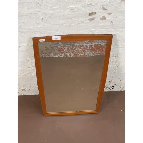 140 - A mid 20th century teak framed wall mirror - approx. 68cm high x 40cm wide