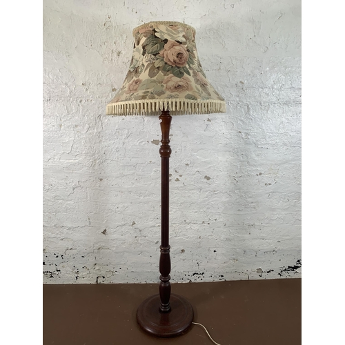 142 - A mahogany standard lamp with circular base - approx. 156cm high including shade