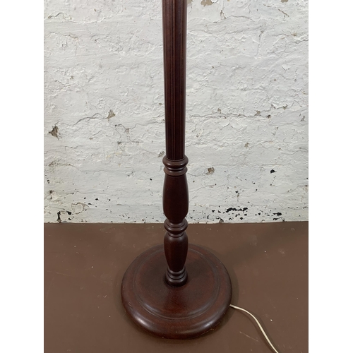 142 - A mahogany standard lamp with circular base - approx. 156cm high including shade