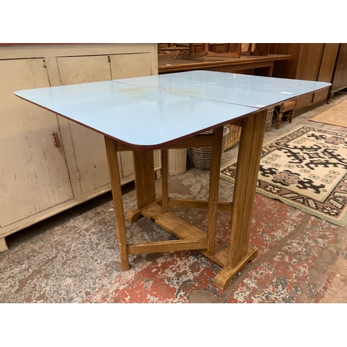 148 - A mid 20th century blue laminate and beech drop leaf gate leg dining table - approx. 74cm high x 75c... 