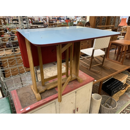 148 - A mid 20th century blue laminate and beech drop leaf gate leg dining table - approx. 74cm high x 75c... 