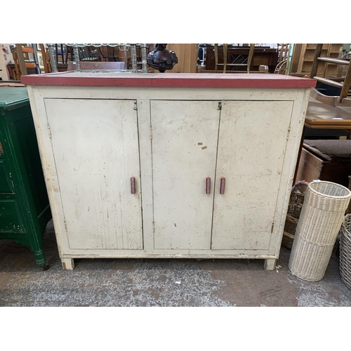 149 - A 1950s red laminate and white painted three door kitchen cabinet - approx. 92cm high x 109cm wide x... 