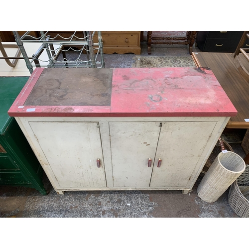 149 - A 1950s red laminate and white painted three door kitchen cabinet - approx. 92cm high x 109cm wide x... 