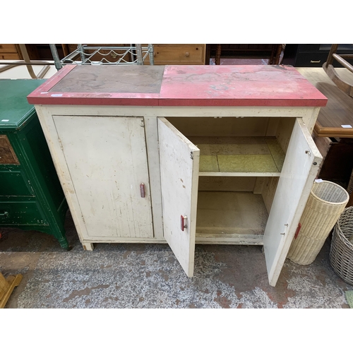 149 - A 1950s red laminate and white painted three door kitchen cabinet - approx. 92cm high x 109cm wide x... 