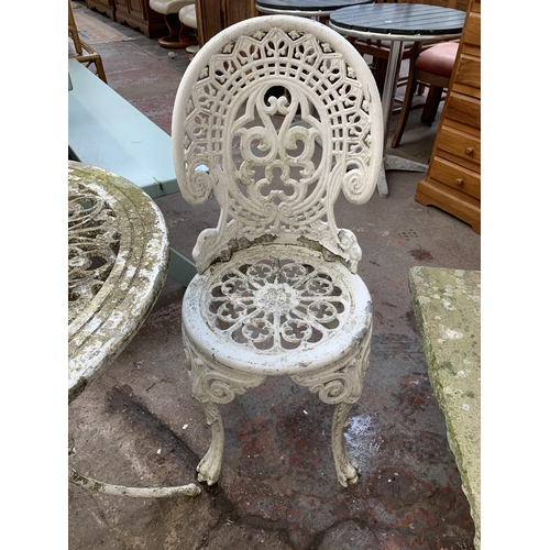 160 - A Victorian style white painted cast metal three piece patio set comprising circular table and two c... 