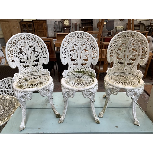 160A - Four Victorian style white painted cast metal patio chairs