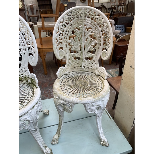 160A - Four Victorian style white painted cast metal patio chairs