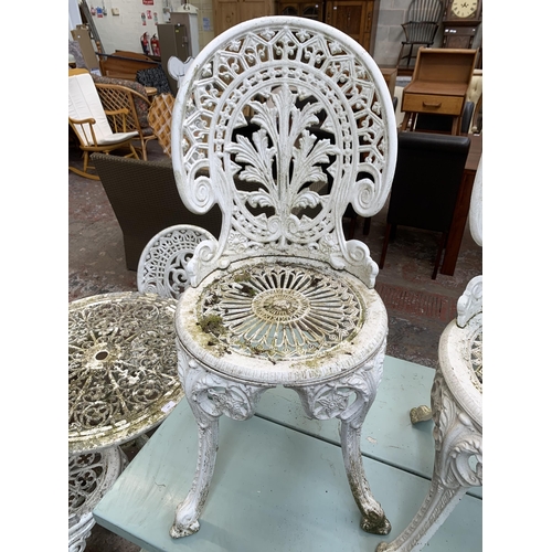 160A - Four Victorian style white painted cast metal patio chairs