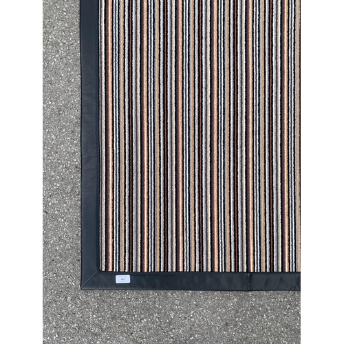 163 - A modern black leatherette and striped rug - approx. 225cm x 160cm