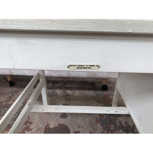 165 - A mid 20th century white painted three drawer office desk bearing label 