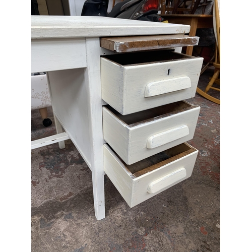 165 - A mid 20th century white painted three drawer office desk bearing label 